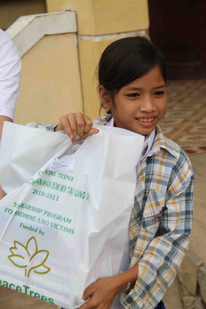 Linh receives her books and supplies for a year of schooling