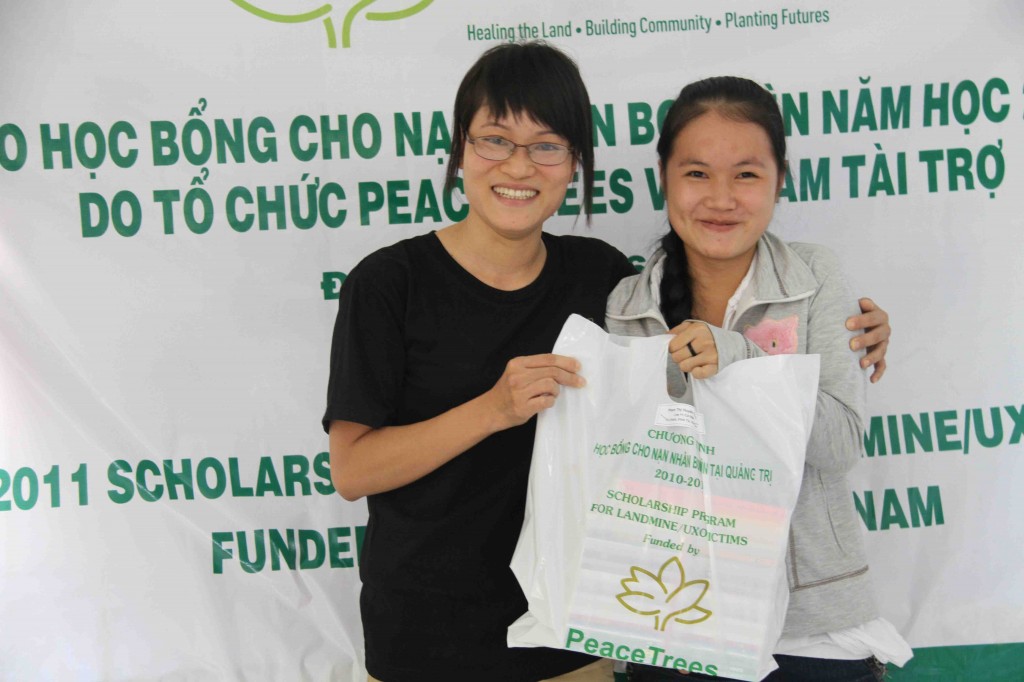Trang accepts her scholarship from PeaceTrees Vietnam